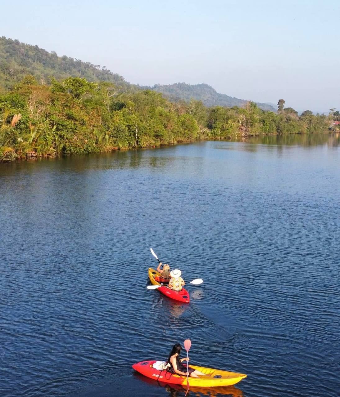 Kayaking below the forested hills