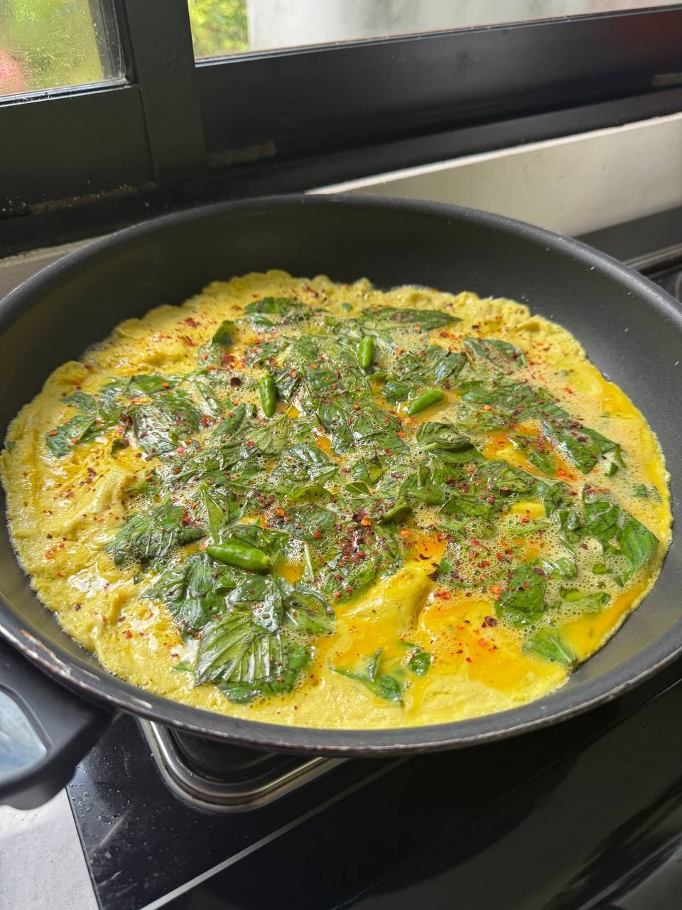 Herb omelette in the pan