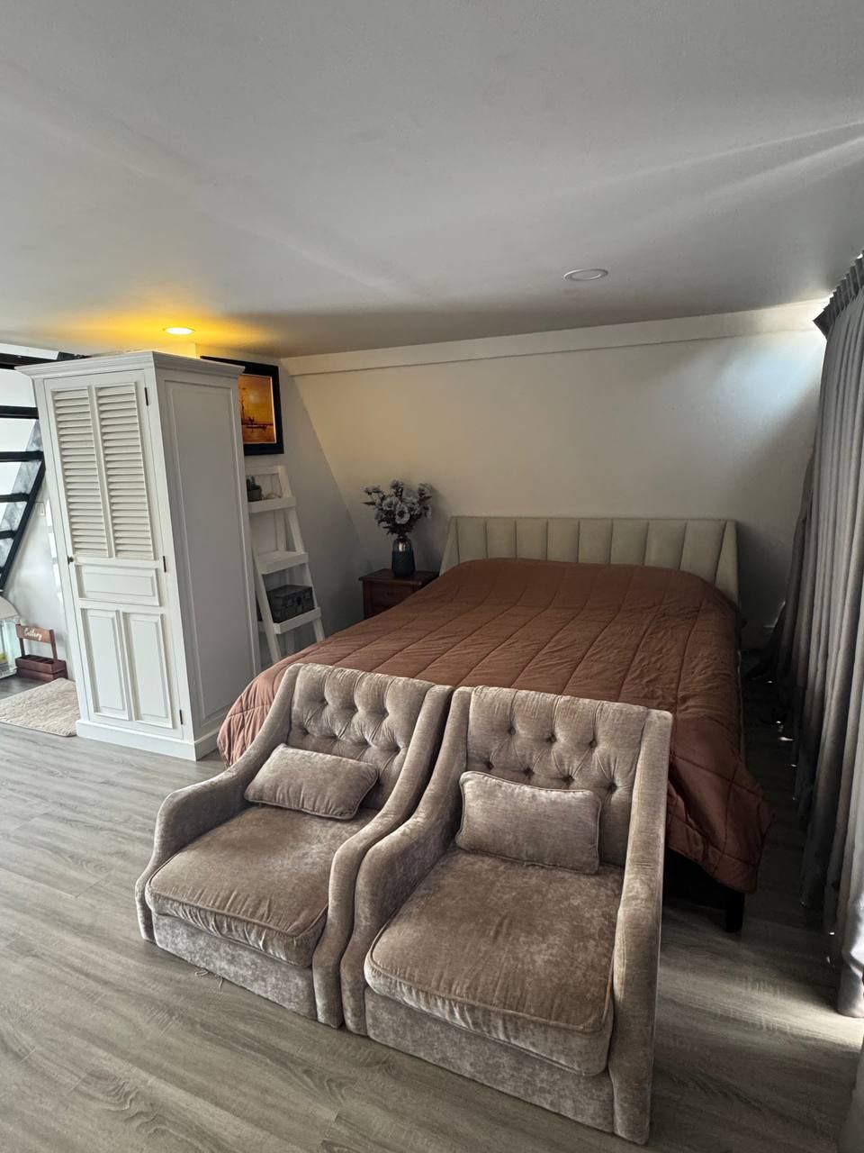 Loft bedroom with armchairs