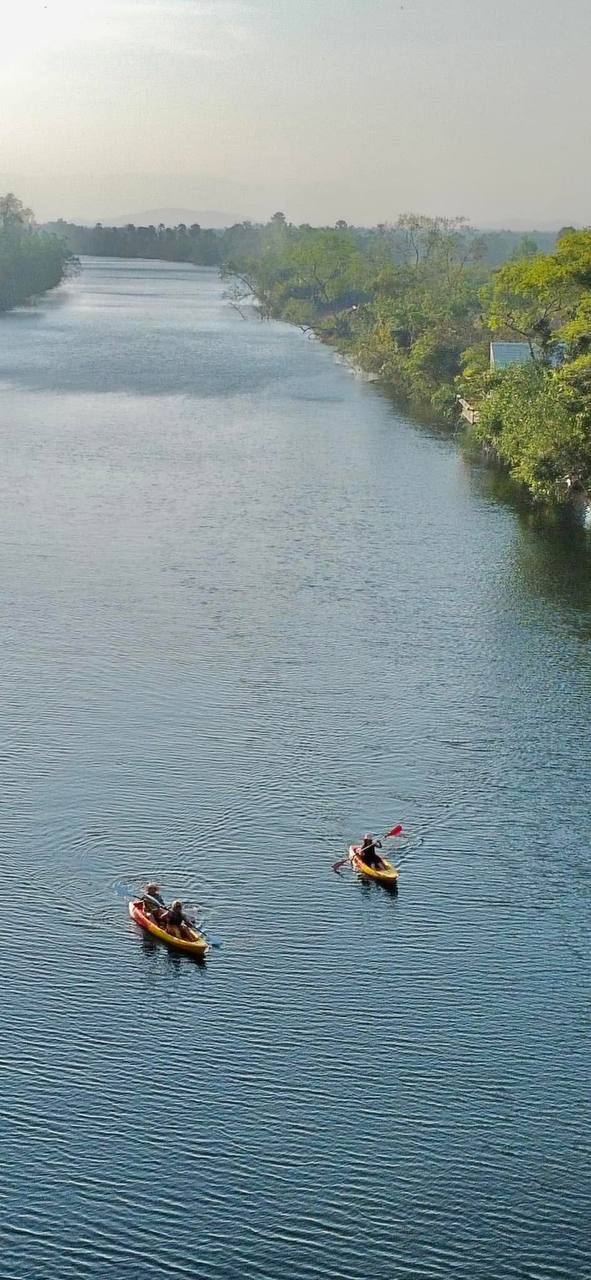 Kayaks on the calm river from above